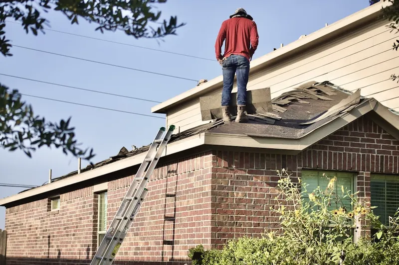 Professional roofer working on a residential roof in Hamlet North